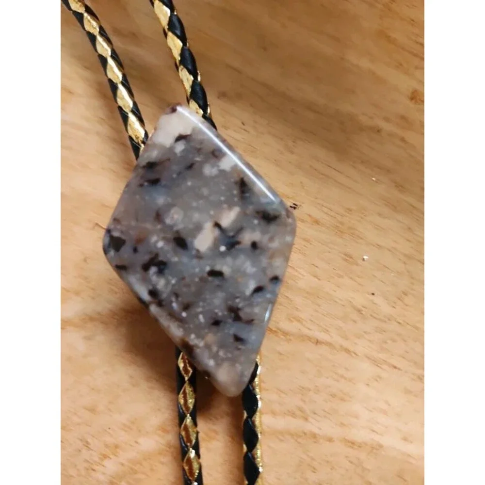 Fancy  agate bolo tie on gold and black cord